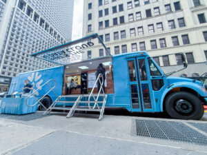 snowflake-school-bus-pop-up-coffee-fintech-tech-activation-01 Branded school bus activation for Snowflake featuring a lodge-inspired interior, AV setup, and hospitality service produced in-house by NVS Visuals.