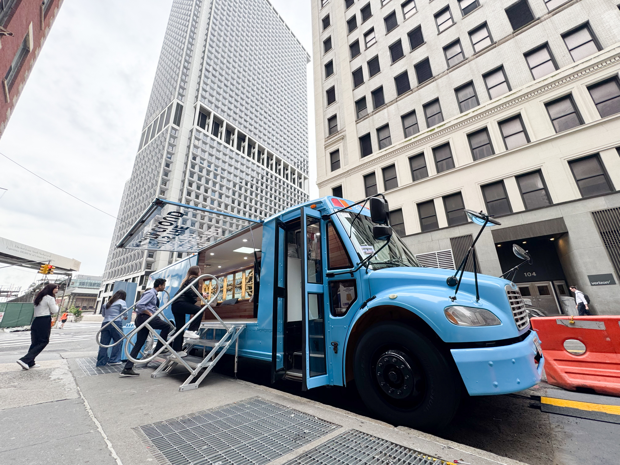 Branded school bus activation for Snowflake featuring a lodge-inspired interior, AV setup, and hospitality service produced in-house by NVS Visuals.