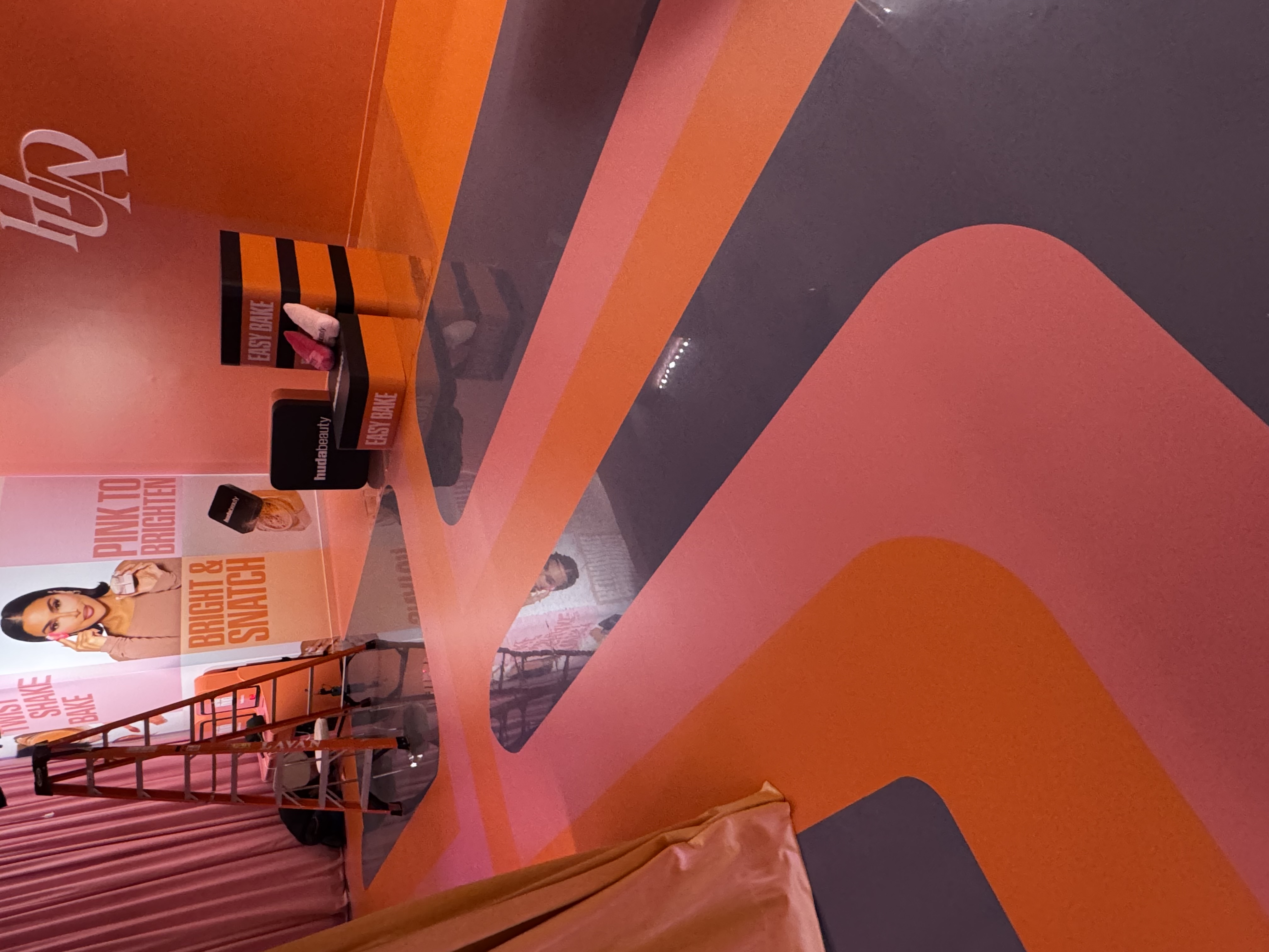 Popup Finished Detail Geometric Wall Finished pop-up interior with geometric pink and orange branded wall — NVS Visuals