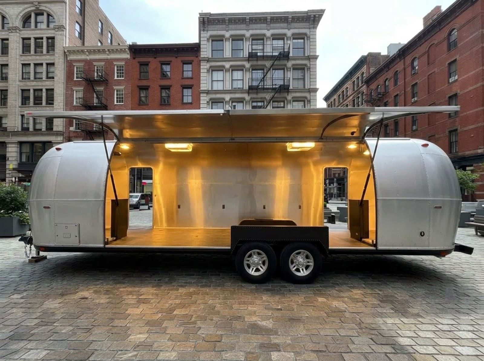 31' Gullwing Airstream — front, pre-branding 31 foot Gullwing Airstream naked polished exterior with single-side gullwing visible