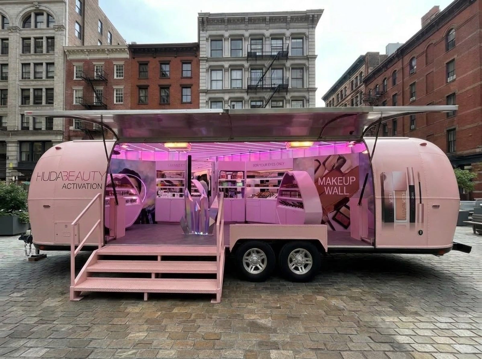 31' Gullwing Airstream — beauty retail concept Concept render of Gullwing Airstream as a beauty activation with pink interior and makeup wall