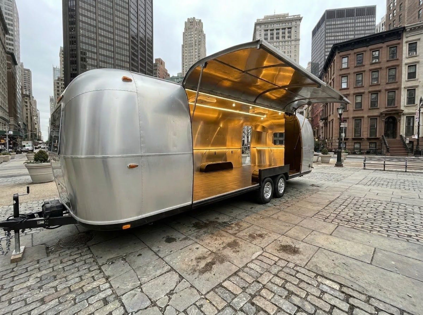 31' Gullwing Airstream — gullwing open, interior empty 31 foot Gullwing Airstream naked polished exterior showing gullwing fully open with empty interior