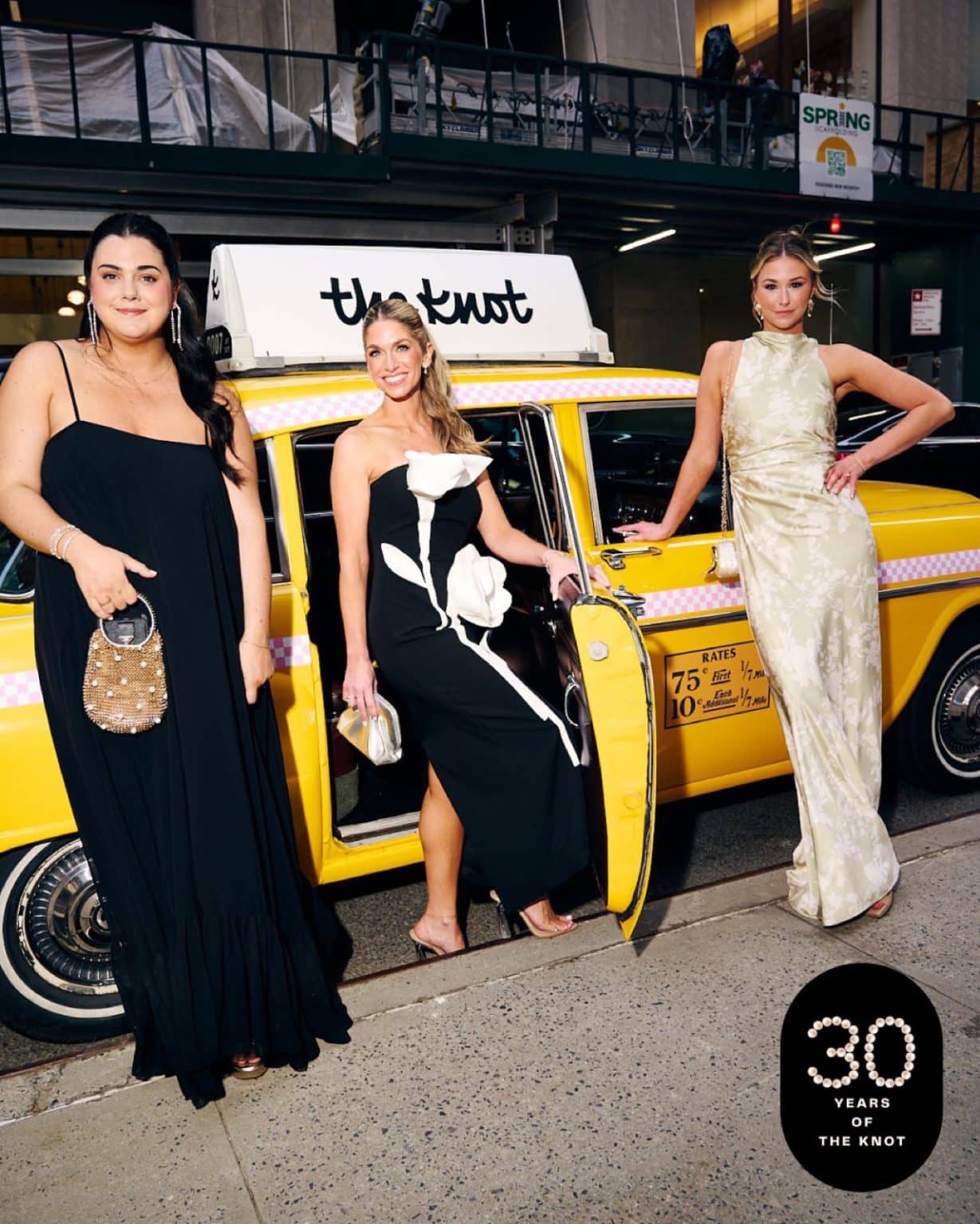 The Knot Gala Checker Cab Guests The Knot 30th Anniversary gala, guests beside the branded Checker cab at night in NYC