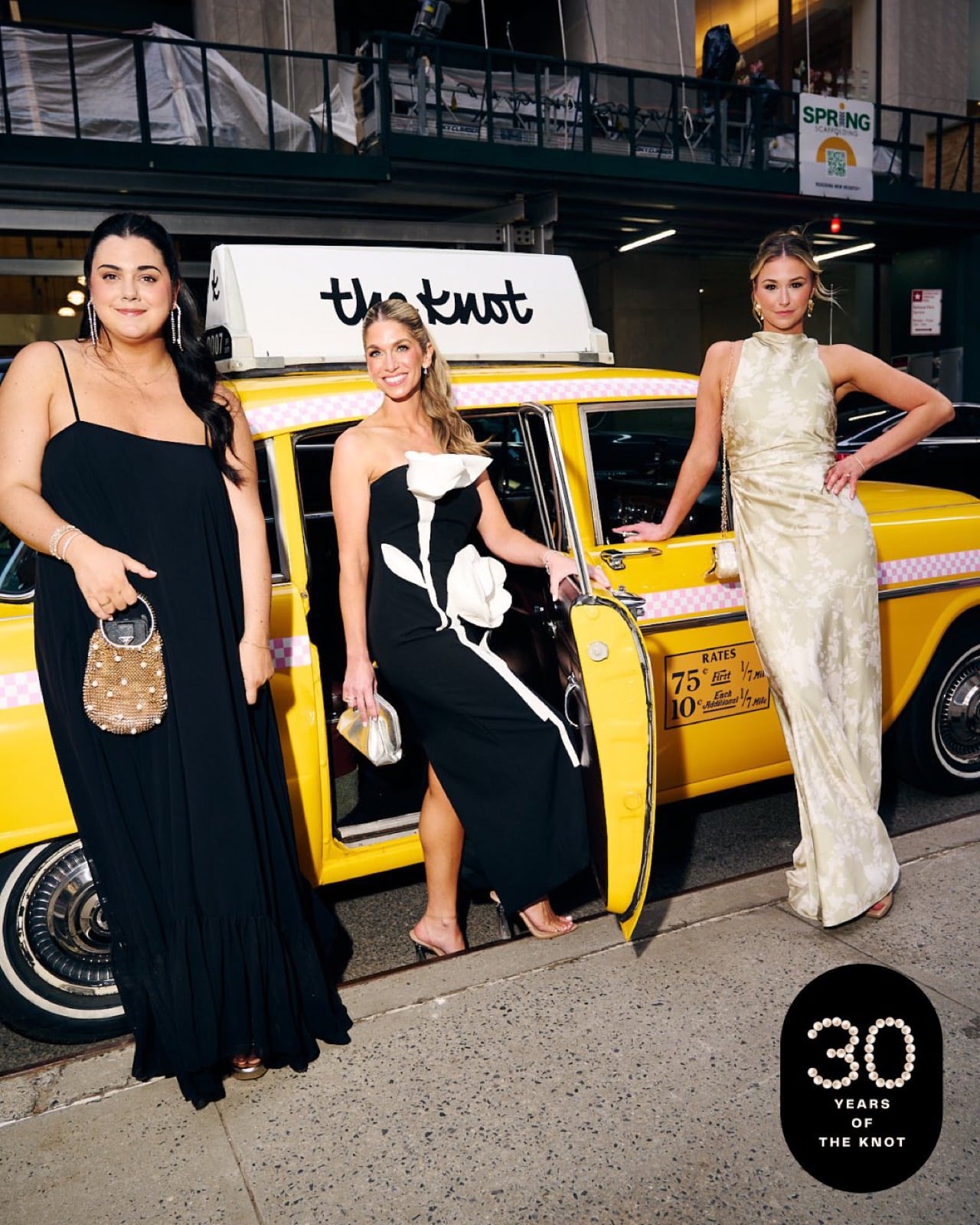 The Knot Gala Checker Cab Guests The Knot 30th Anniversary gala, guests beside the branded Checker cab at night in NYC