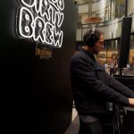 DJ performing at the custom Club Dirty Brew DJ booth