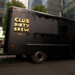 Matte black Kurbmaster bar truck with 3D gold drip Club Dirty Brew lettering at Manhattan West