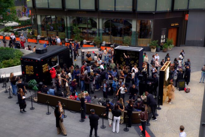 Aerial view of Belvedere Club Dirty Brew activation at Manhattan West Plaza with Aerial view of Belvedere Club Dirty Brew activation at Manhattan West Plaza with crowd, bar truck and gold mirror wall