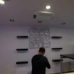 Bar truck interior build-out with shelving and neon logo