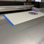 Printing the Tatcha crest graphic on the NVS Visuals flatbed printer