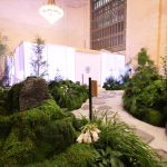 Moss garden with sculpted stones and stacked-stone speaker covers, Tatcha Grand Central