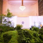 Moss hillside and plexiglass tea pavilion beneath the Vanderbilt Hall chandelier, Grand Central