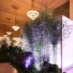 Corner of the Tatcha tea pavilion with sculpted rock and moss landscape under Grand Central chandeliers