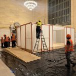 Crew raising the Tatcha tea pavilion frame during load-in at Grand Central Vanderbilt Hall