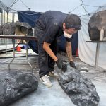 NVS Visuals fabricator sculpting and painting foam rocks for the Tatcha moss garden