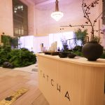 Custom white oak veneer Tatcha welcome desk fabricated by NVS Visuals