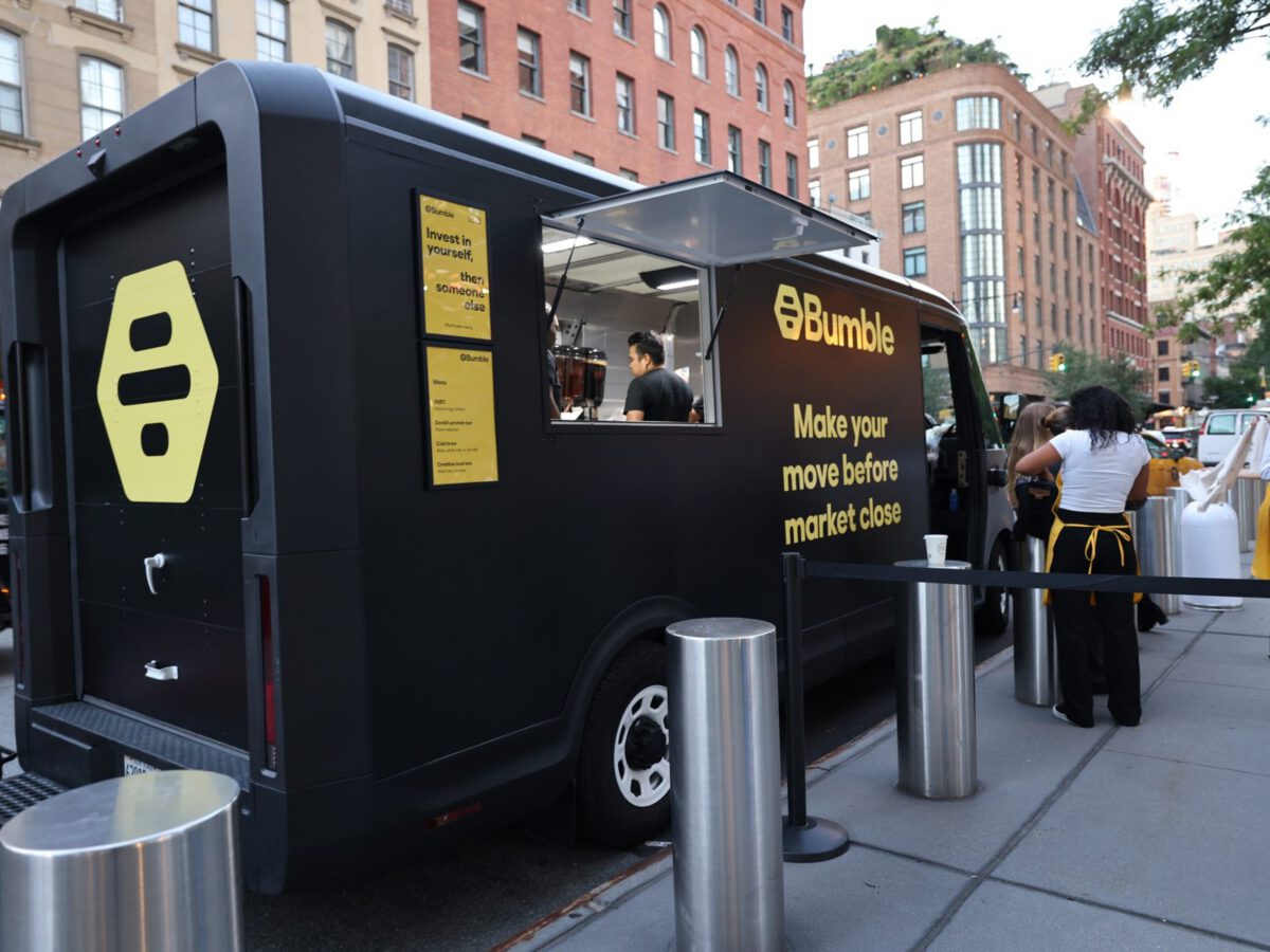 Bumble EV food truck NVS EV Food Truck wrapped black for Bumble with service window open on a NYC plaza
