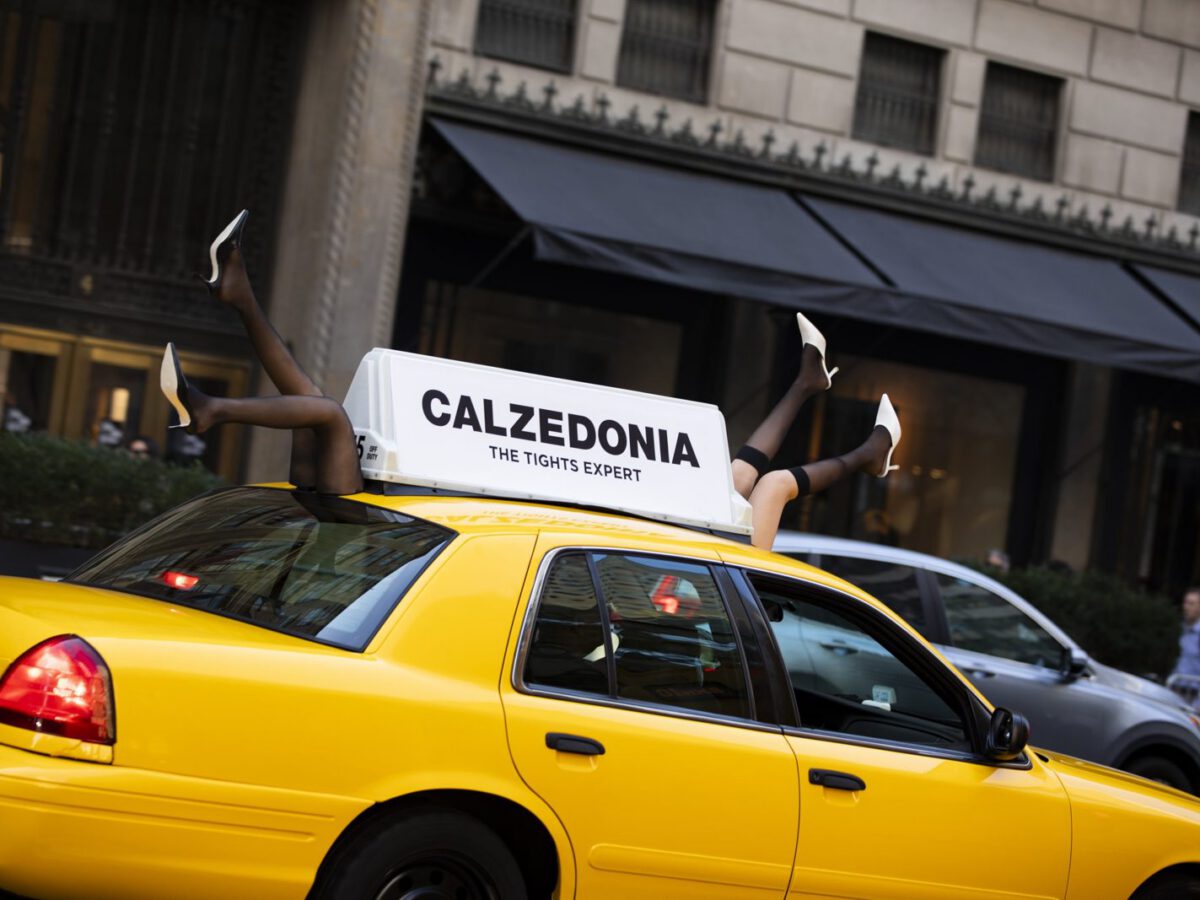 Calzedonia legs-in-tights cab topper Calzedonia-branded vintage NYC yellow cab with legs-in-tights roof topper on a NYC street