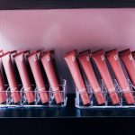 Dewy Lip Shine tubes displayed in acrylic holders