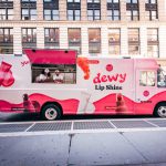 Pink eos Dewy Lip Shine truck parked on Broadway in SoHo