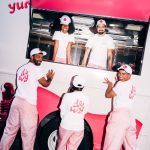 NVS crew in white eos hats and pink uniforms at the truck window