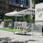 Branded Farmacy cart and striped umbrellas by NVS