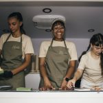 Three servers making froyo inside the Farmacy truck