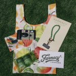 Farmacy giveaway tote, camera and balm on astroturf