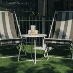Striped lounge chairs and picket fence built for the Farmacy activation