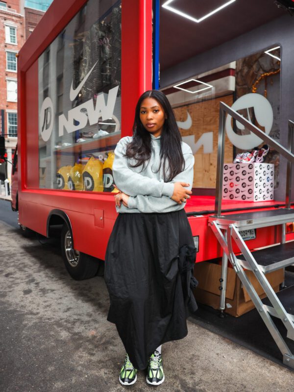 JD x Nike NSW glass truck guest Guest posing in front of the JD × Nike NSW glass truck