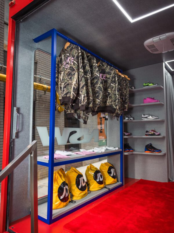 Nike Fleece glass truck interior Nike Fleece interior — shoe wall, fleece rail and JD bags on a red carpet floor