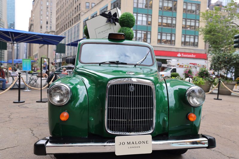 Jo Malone London cab front Jo Malone London taxi head-on, chrome grille with gift box and topiaries on the roof