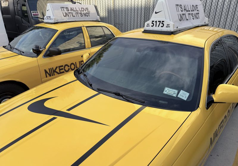 NikeCourt Swoosh on yellow cab hood NikeCourt-branded vintage NYC yellow cab with black Swoosh across the hood