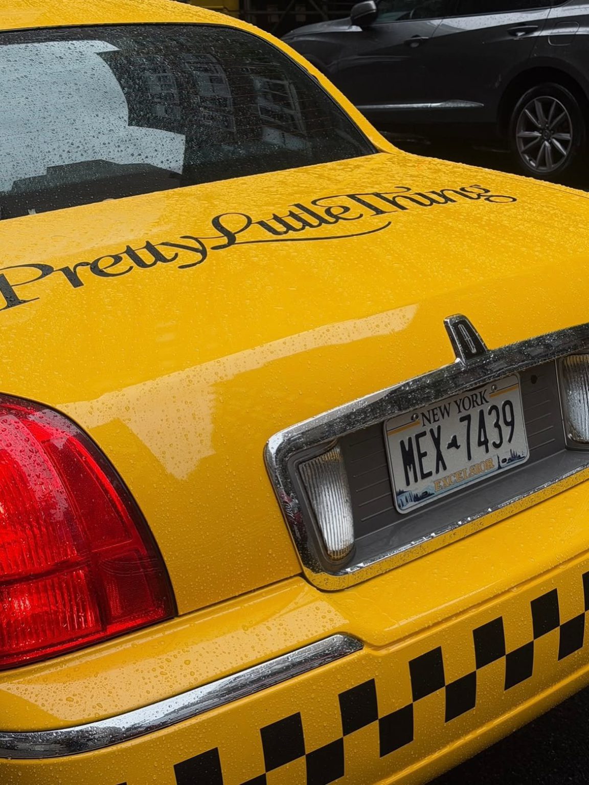 PrettyLittleThing branded yellow cab PrettyLittleThing script logo on the trunk of a vintage NYC yellow cab