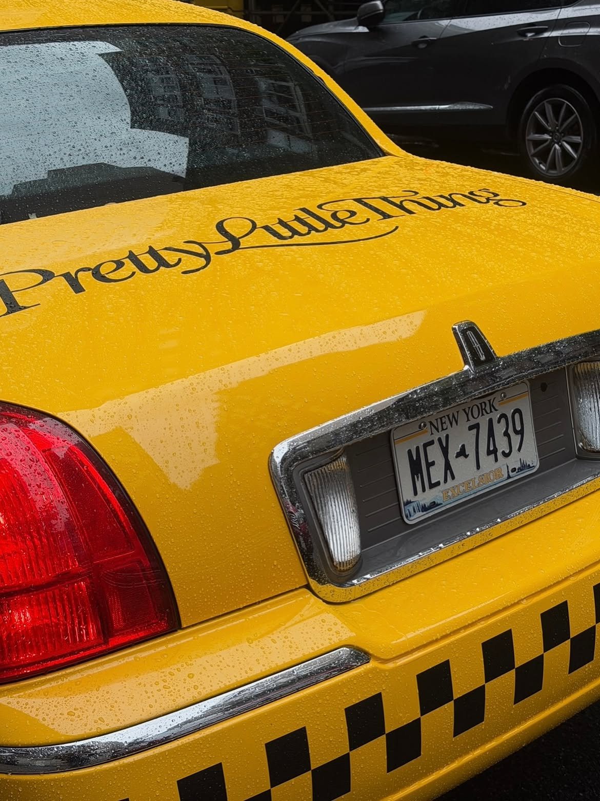 PrettyLittleThing branded yellow cab PrettyLittleThing script logo on the trunk of a vintage NYC yellow cab
